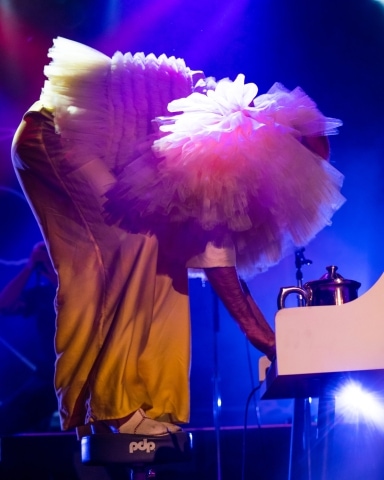 Jake Wesley Rogers plays the piano while standing on top of his stool at Bimbo's in San Francisco