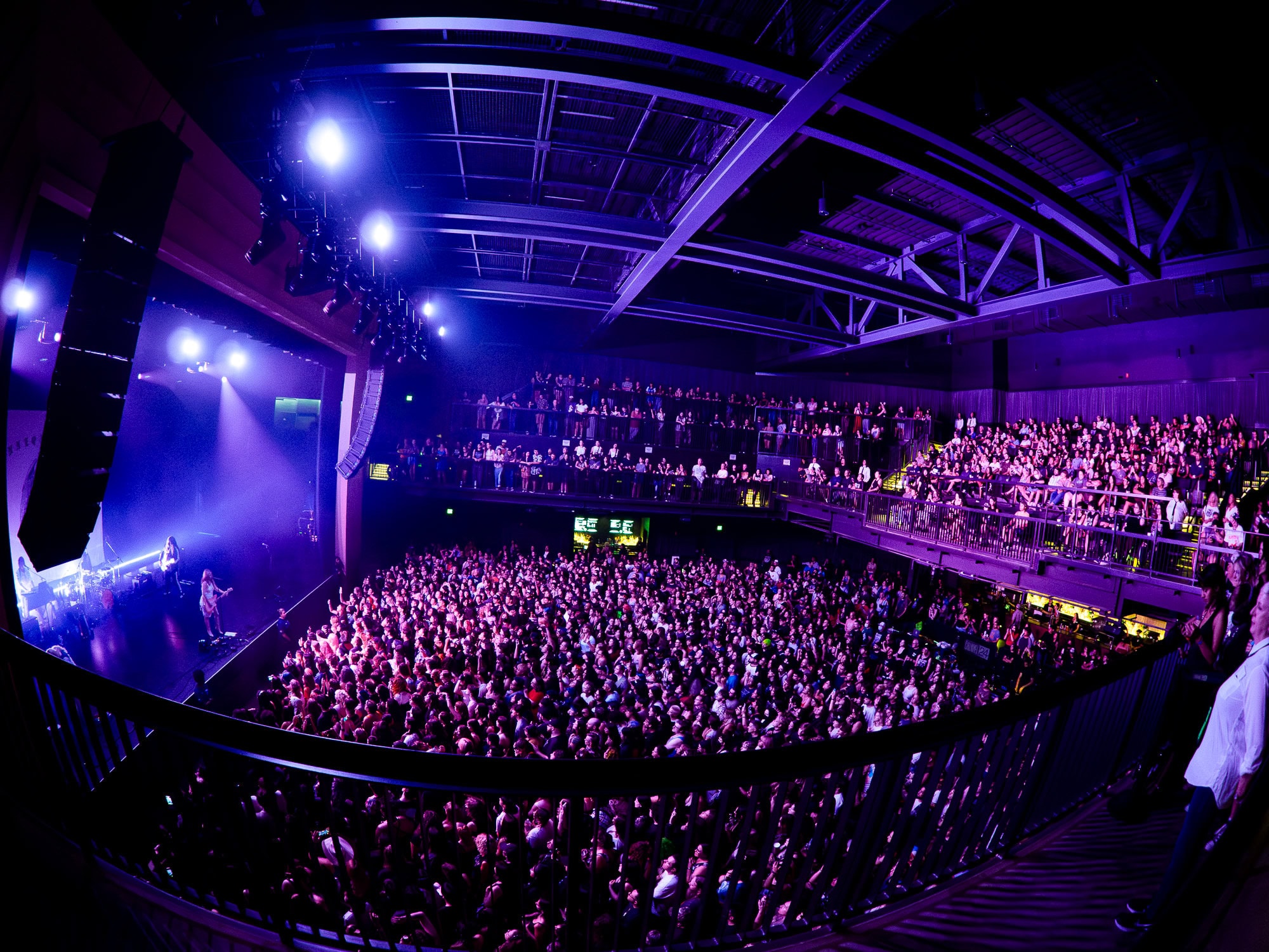 A large crowd of people in a concert hall.